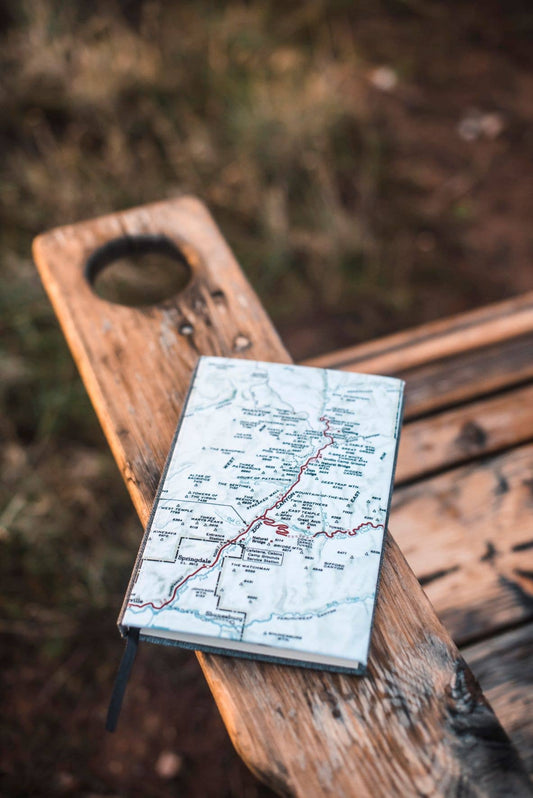 Vintage map journal on a wooden bench