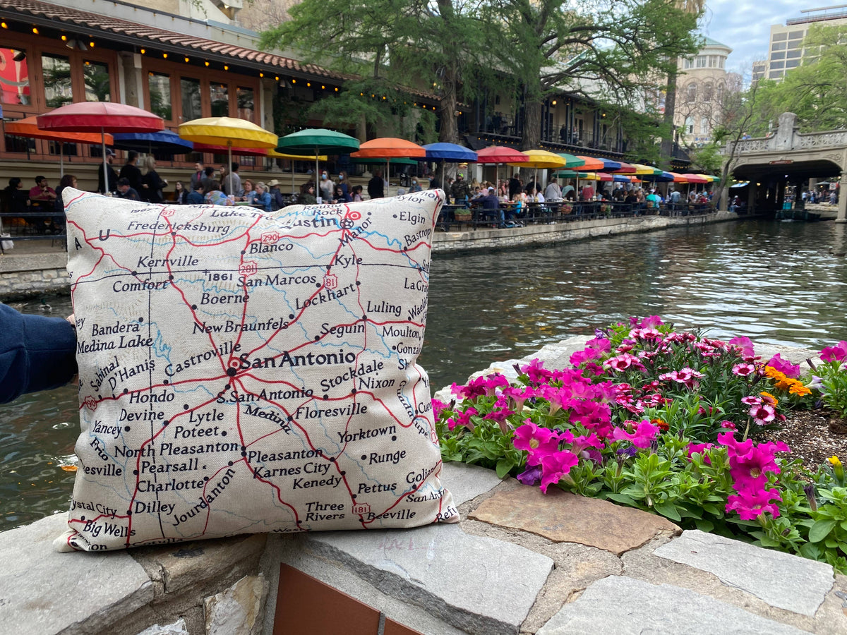 Vintage map pillow outdoors by the river