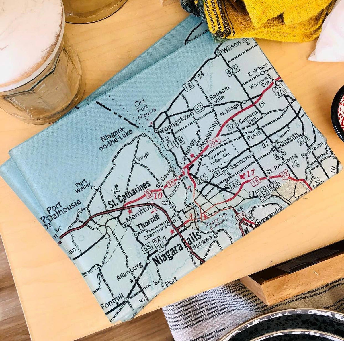 Vintage map glass cutting board on a kitchen table