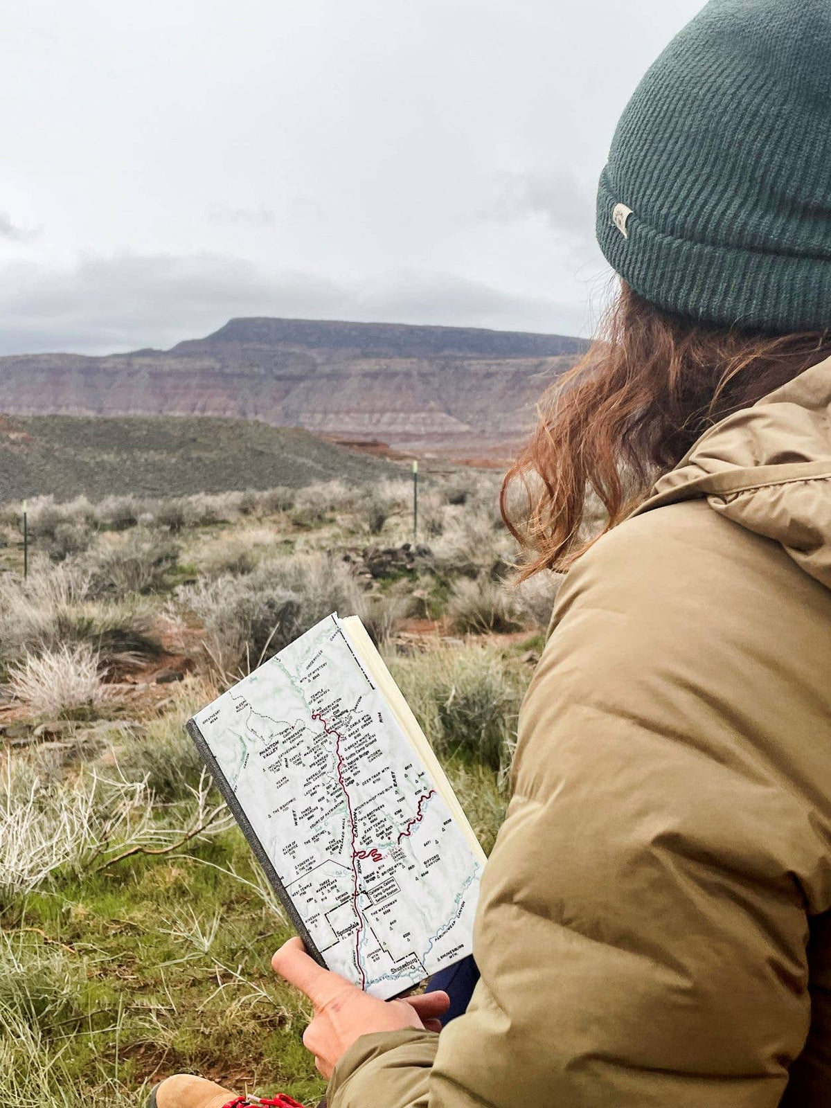 Hiker reading a vintage map journal