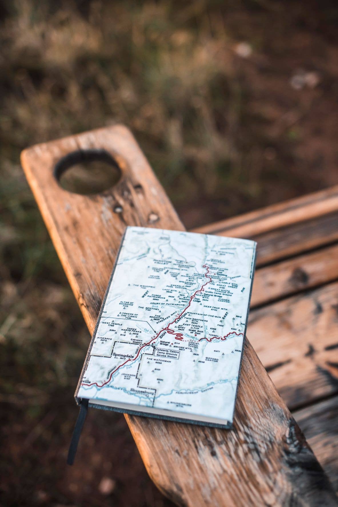Vintage map journal on a wooden bench