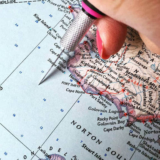 Vintage map being cut by hand in the studio