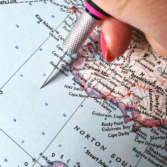Vintage map being cut by hand in the studio