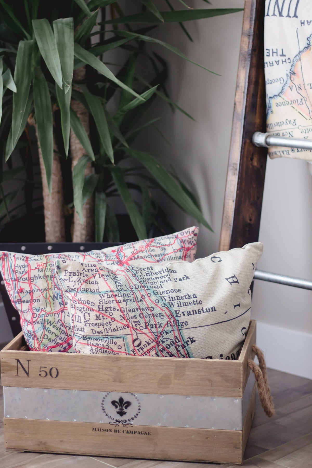 Vintage map pillow in a wooden crate