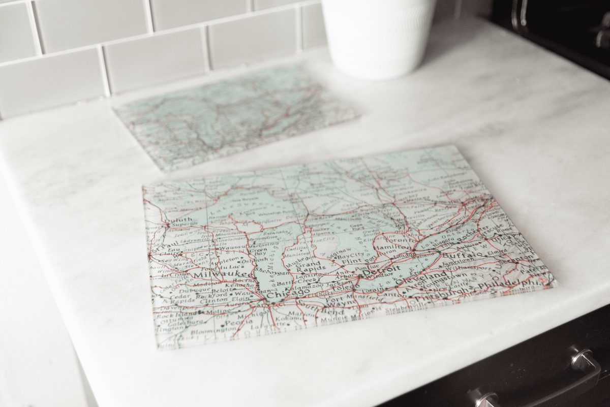 Vintage map glass cutting boards on a kitchen counter