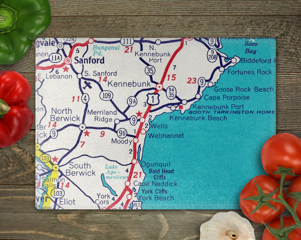 Wells Maine vintage map glass cutting board featuring Ogunquit Kennebunkport and York Beach with turquoise water and red roads on a wooden surface