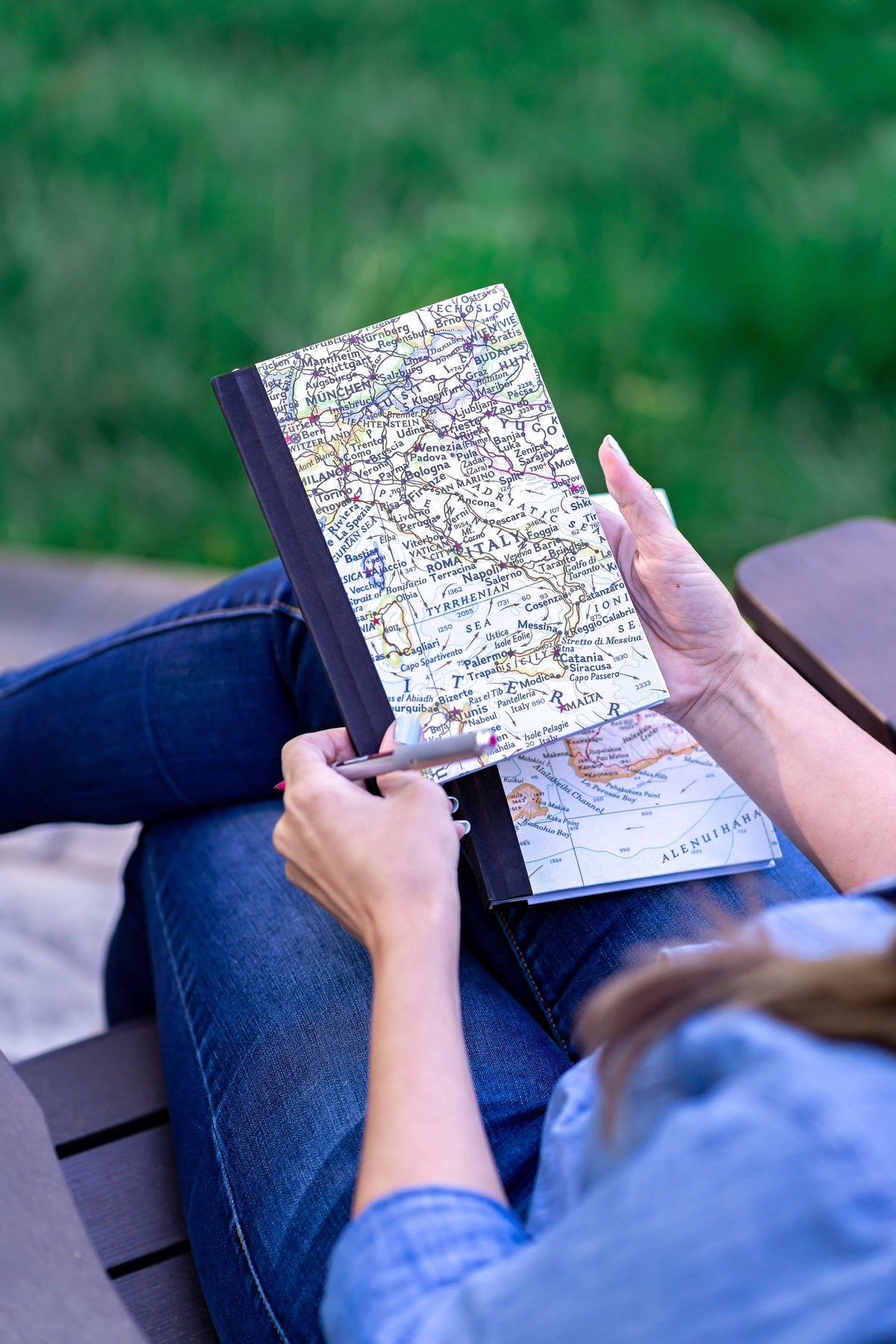 Reading a vintage map journal outdoors