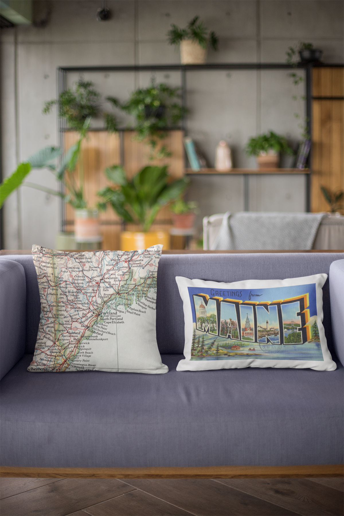 Vintage map pillows on a gray sofa