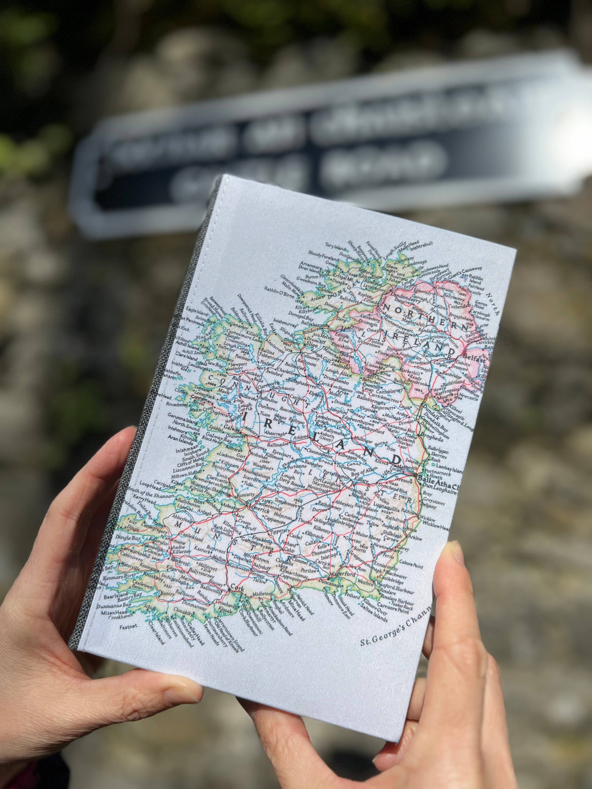 Holding a vintage map journal