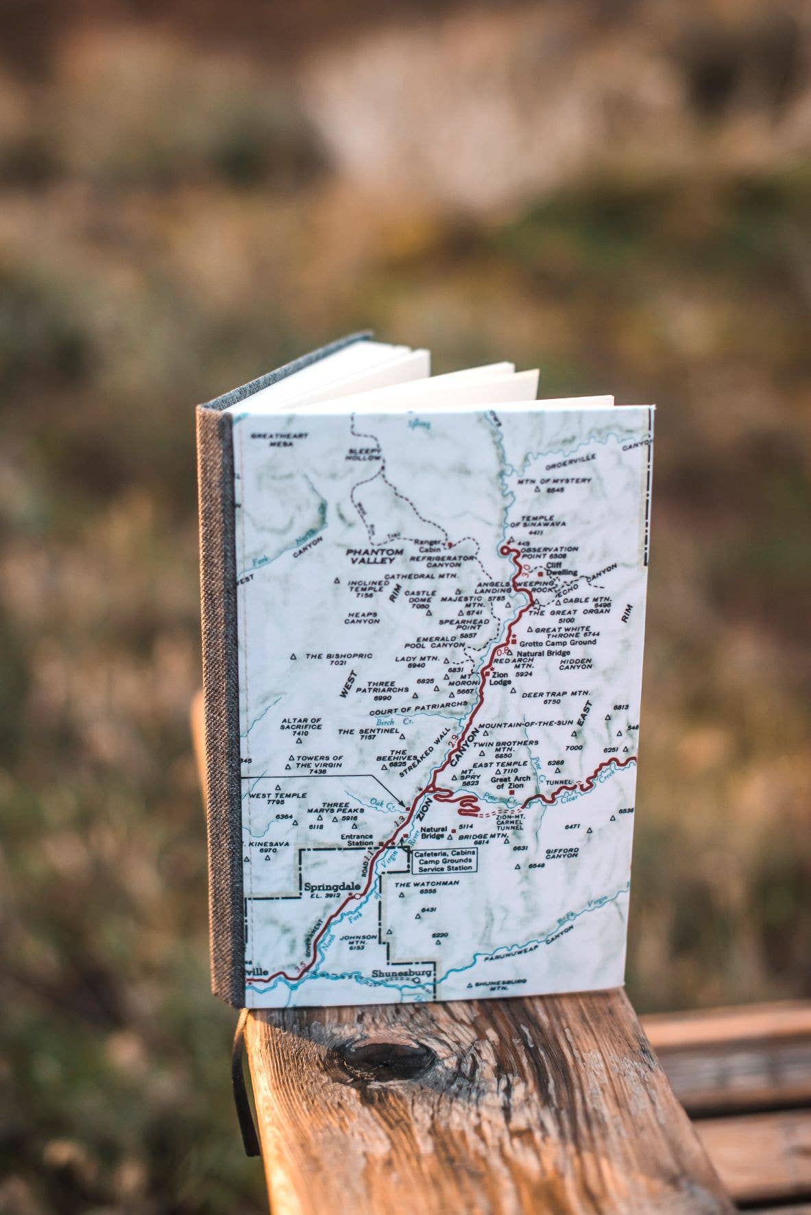 Vintage map journal outdoors at golden hour