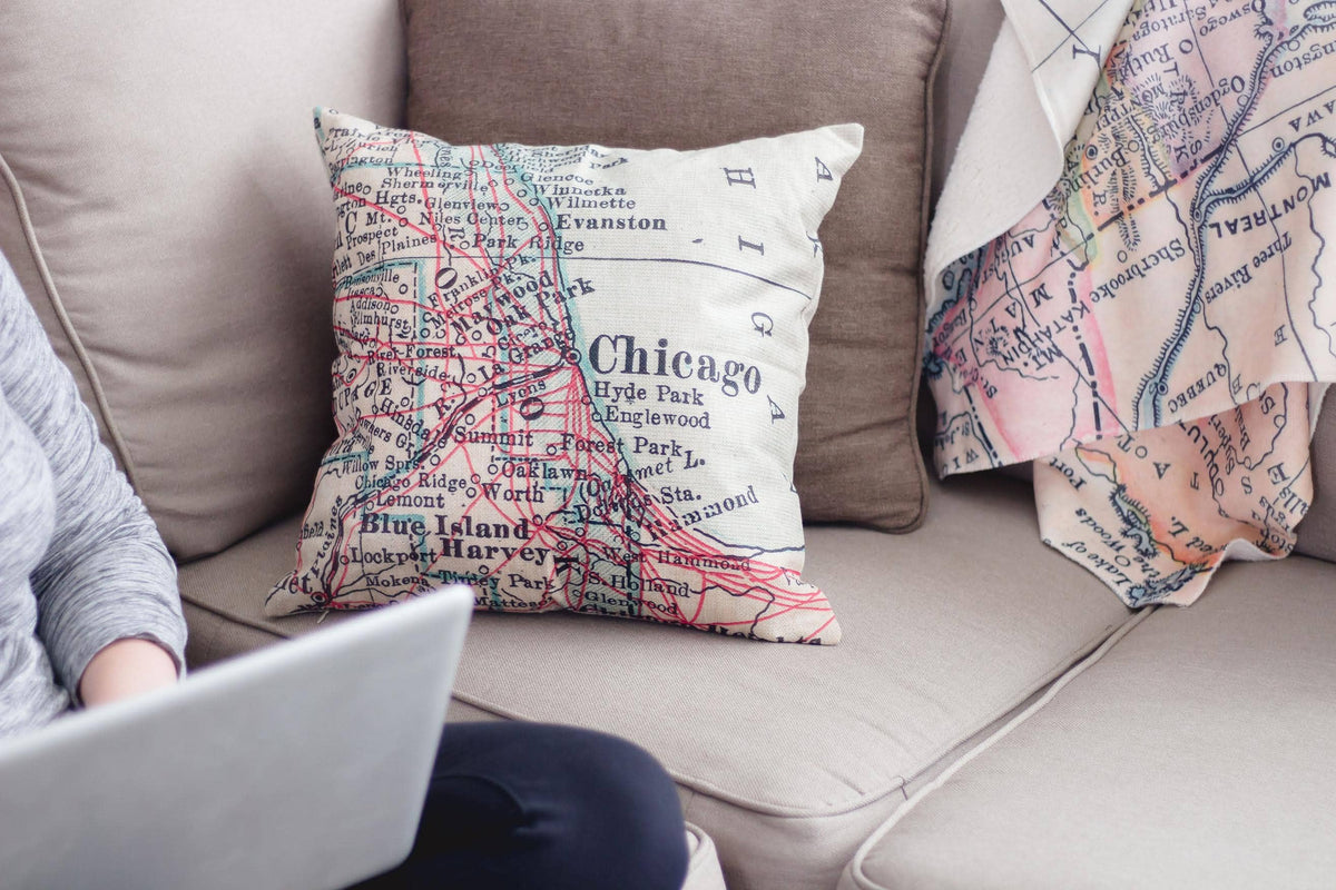 Vintage map throw pillow on a sofa